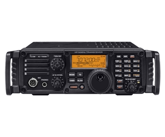 A picture of the Icom IC-7200. The display is reading 7.072. This model has the carry handles attached.