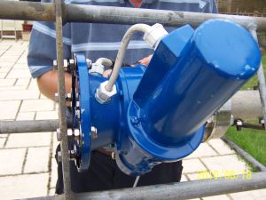 In this photo the tower has been tilted over and the rotator is being bolted to the cage on the tower.